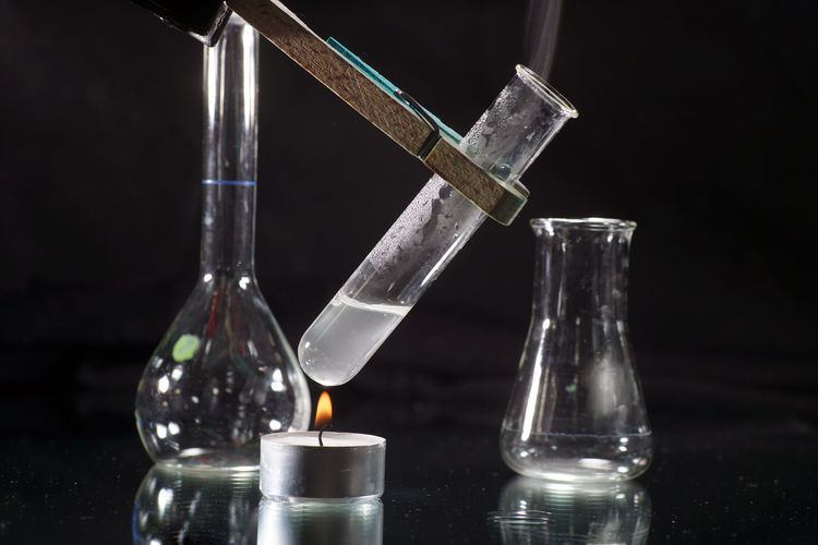 Close-up of liquid in test tube over lit tea light