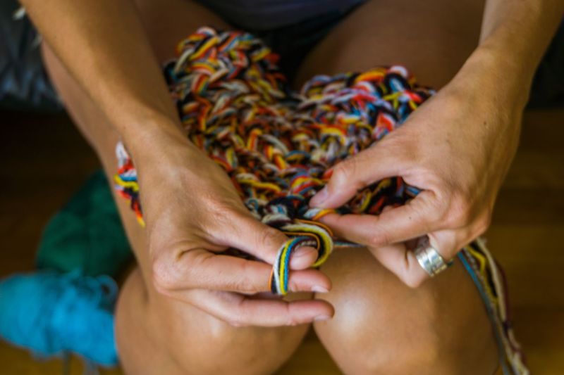 Midsection of woman holding colorful wool