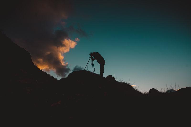 Low angle view of silhouette man against sky during sunset