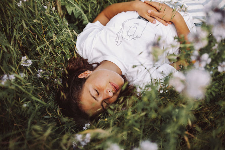 High angle view of young woman sleeping on grass