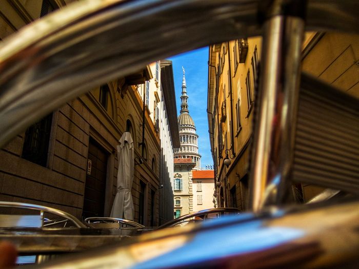 Cars on road amidst buildings in city