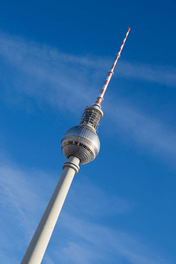 Low angle view of fernsehturm tower against blue sky