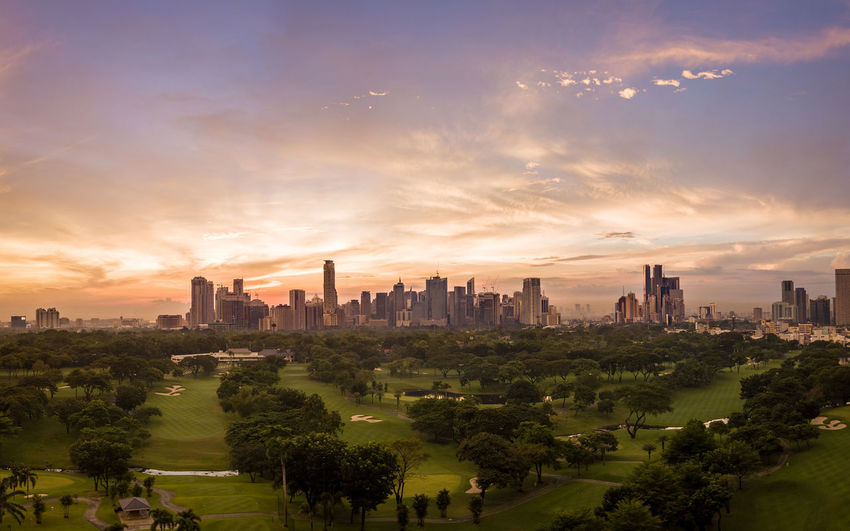 Panorama aerial drone picture of the skyline of makati in metro manila, philippines during sunset