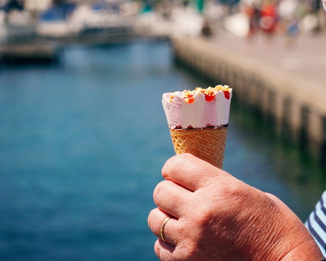 Cropped hand of man holding ice cream cone