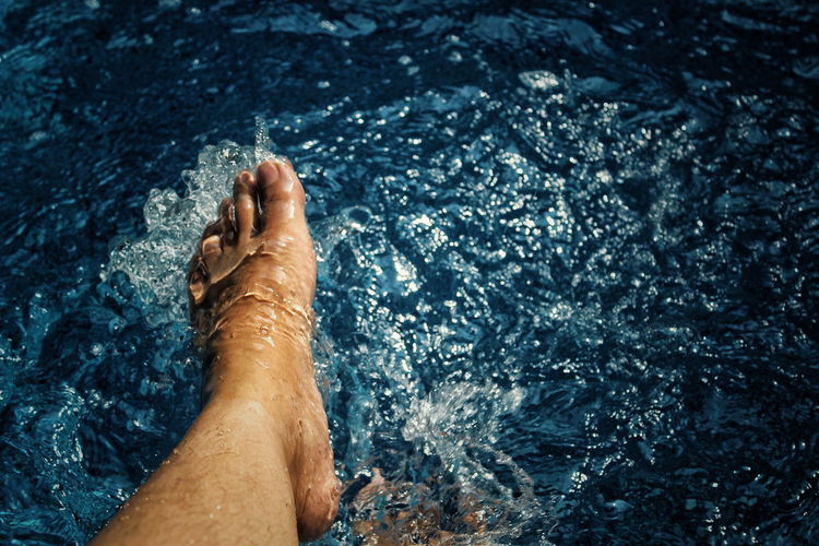 Low section of person legs in water