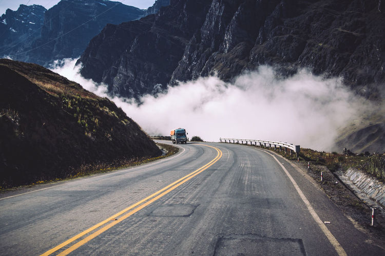 Truck on country road against mountains