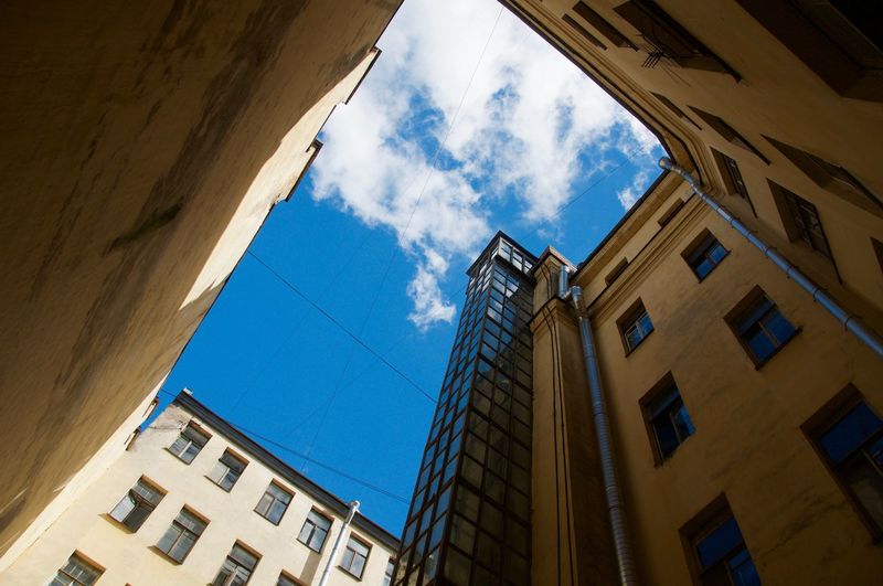 Low angle view of building against cloudy sky