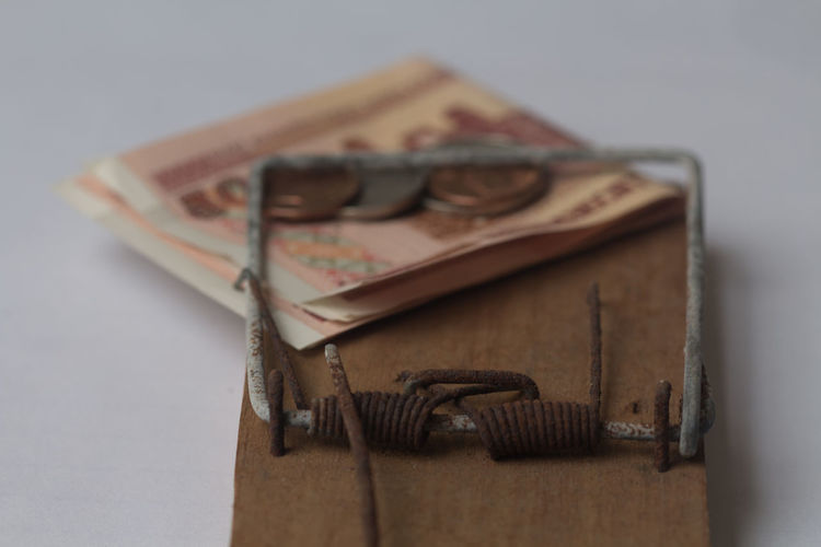 Close-up of currencies and trap on table