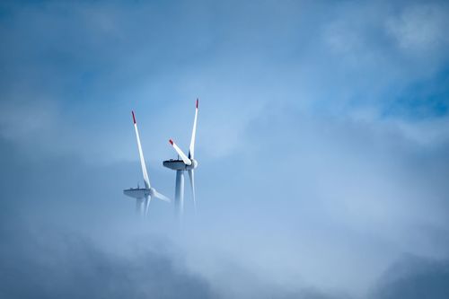 LOW ANGLE VIEW OF WINDMILL IN SKY
