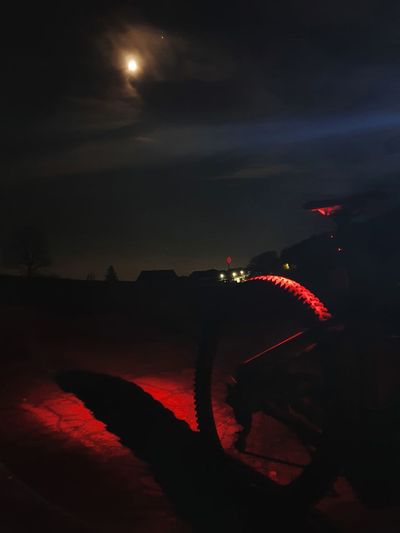 Silhouette man against illuminated sky at night