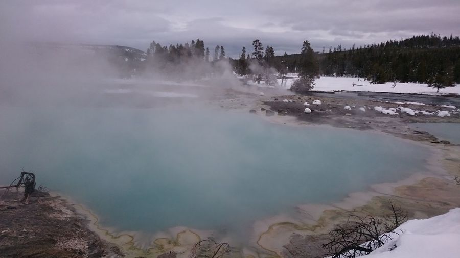 Hot spring in yellowstone national park against sky