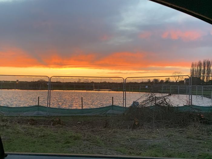 Scenic view of river against sky during sunset