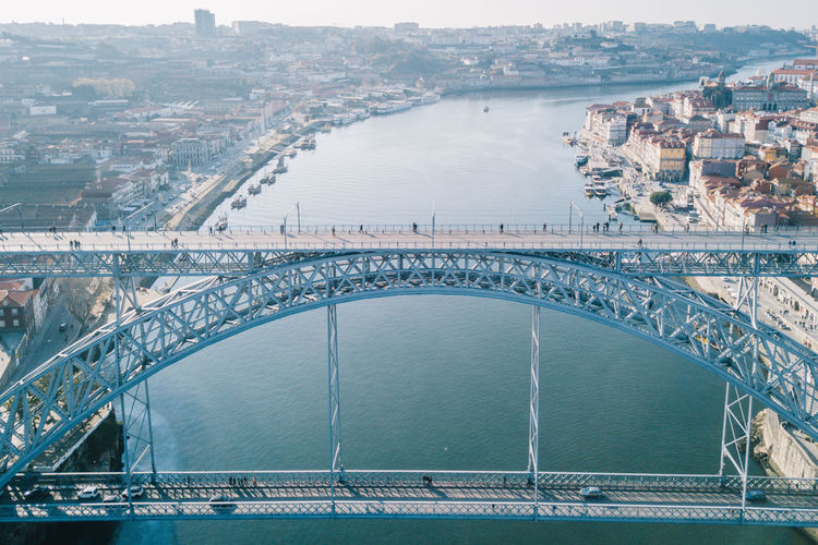 Aerial view of arch bridge over river in city