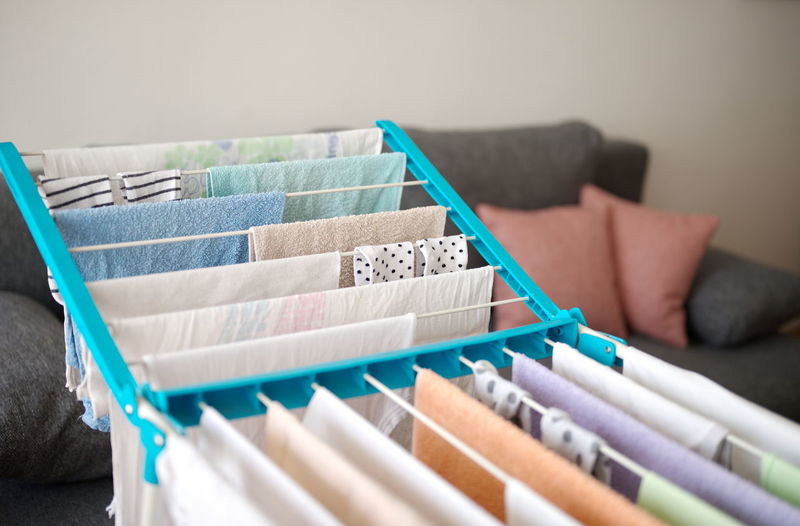 Drying laundry on drying rack in a small living room