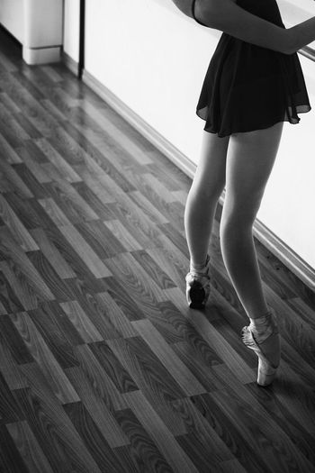 Low section of female ballerina tiptoeing