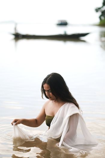 Woman sitting in a lake