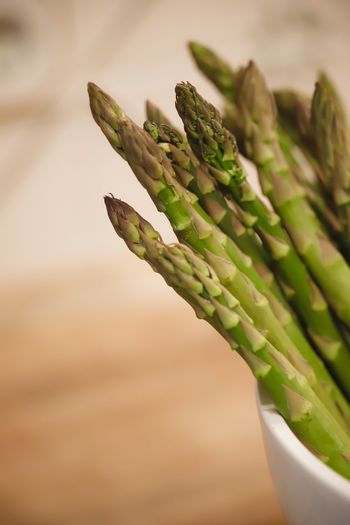 Close-up of green asparagus on table