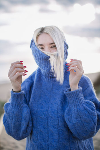 Young woman wearing mask standing in winter