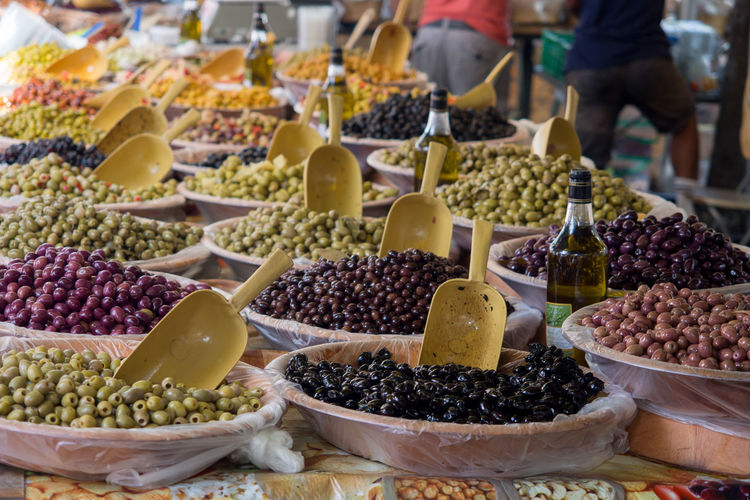 Close-up of various olives for sale at market stall