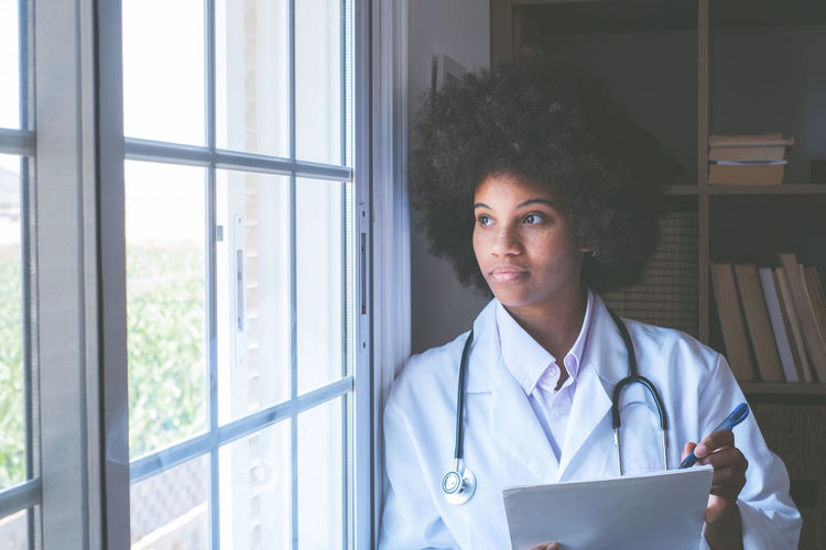 Doctor looking through window at clinic