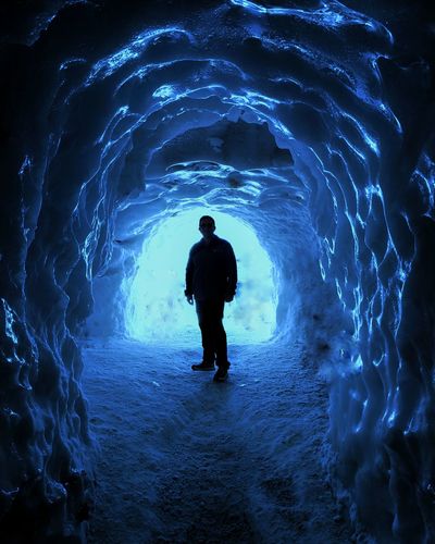 Portrait of man standing in cave during winter