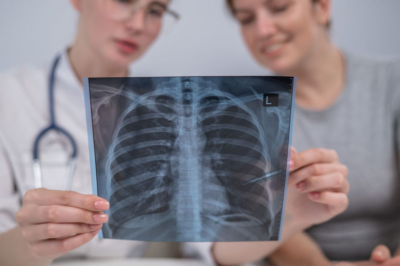Midsection of doctor examining patient