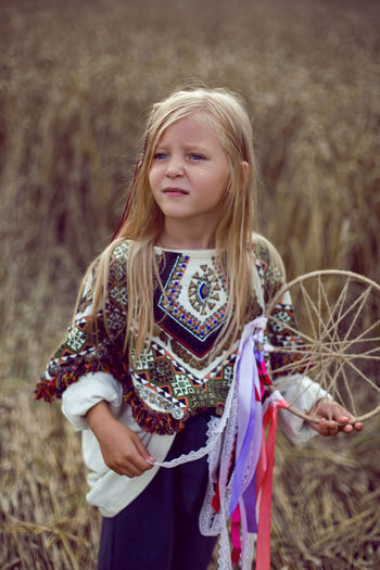Girl indian shaman blonde in a poncho and a dream catcher