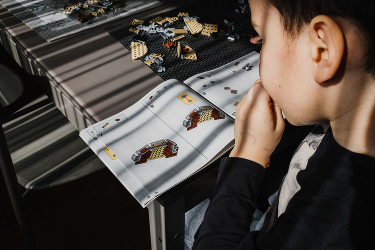 21.03.2022. batumi, georgia. boy child manually folds lego constructor at the table. star wars. 