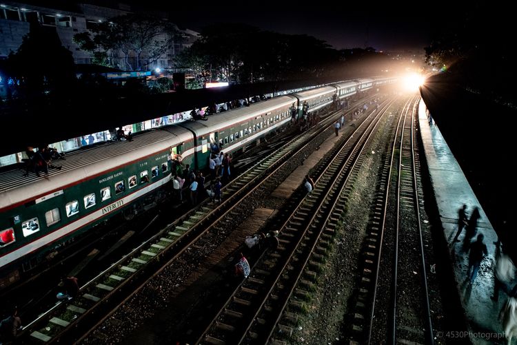 High angle view of people and train on railroad tracks at night