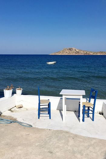 Chairs and table by sea