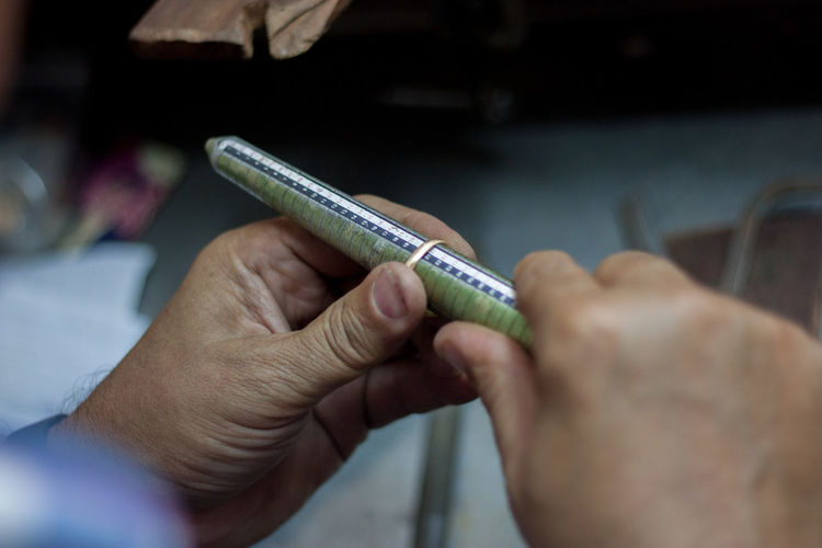 Cropped image of jeweler shaping ring with rasp in workshop