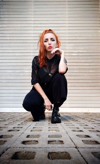 Red hair girl in black posing looking at the camera