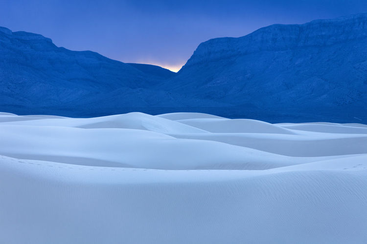 Idyllic shot of white sands national monument against mountains during sunset
