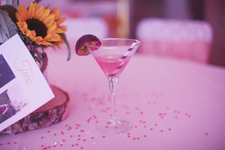 Close-up of glass of pink flower on table