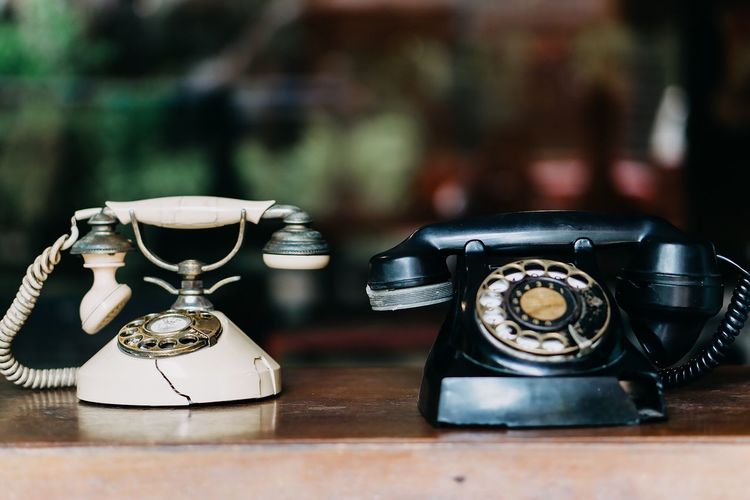 Close-up of old-fashioned telephones on table