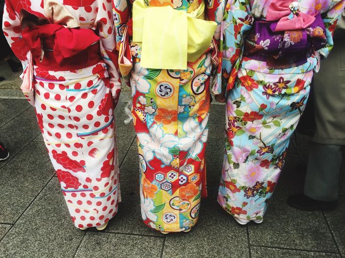 Low section of women in kimono standing on floor