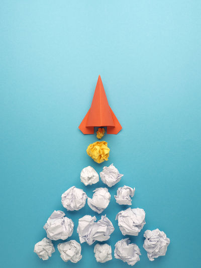 Directly above shot of crumpled paper balls on blue background