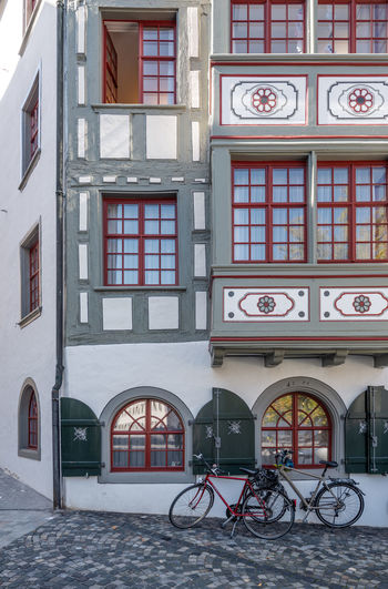 Bicycles on street by buildings in city