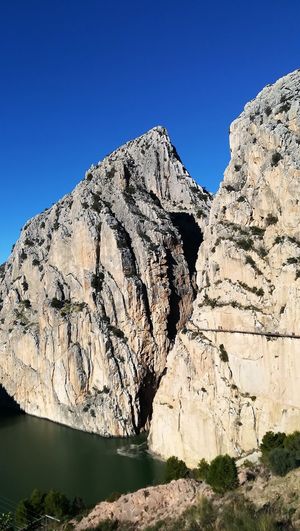 Scenic view of mountain against clear blue sky