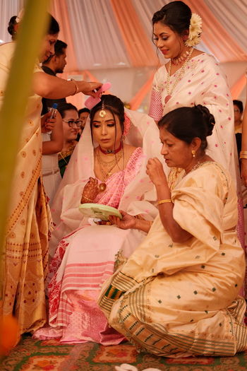 Females performing rituals during wedding ceremony