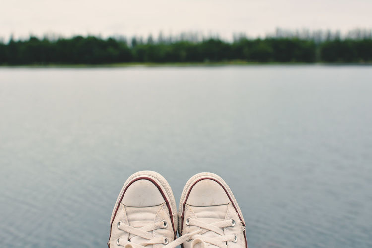 Low section of shoes on water