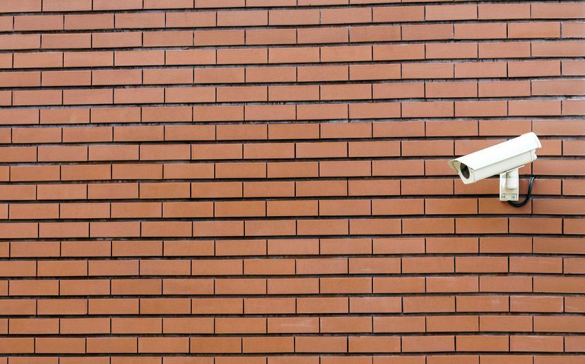 Security camera against brick wall
