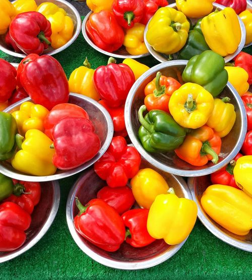 High angle view of bell peppers in container at market stall