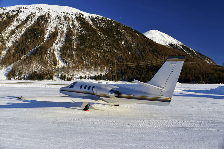 Airplane on snow covered mountain