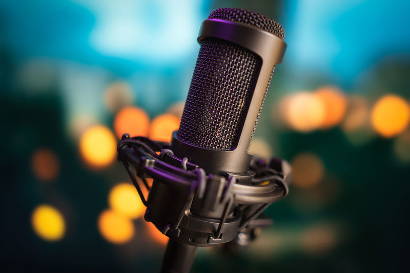 Professional studio  microphone on background with bokeh lights in cinematic style tonight colors