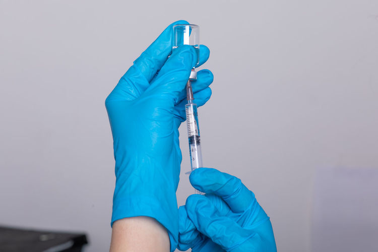 Doctor holding syringe and medicine in hospital