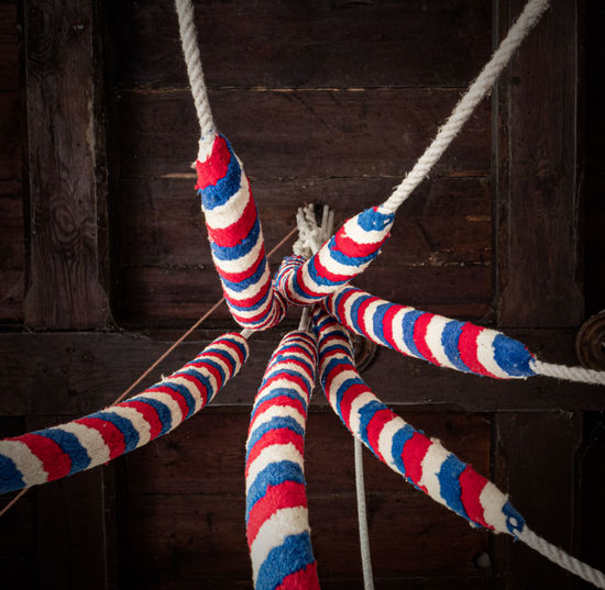 Close-up of multi colored rope hanging on wood