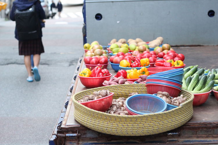 Fruits and vegetables in containers at market stall