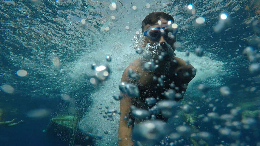 Shirtless man snorkeling in sea