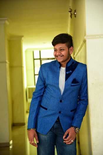 Smiling young man standing in corridor